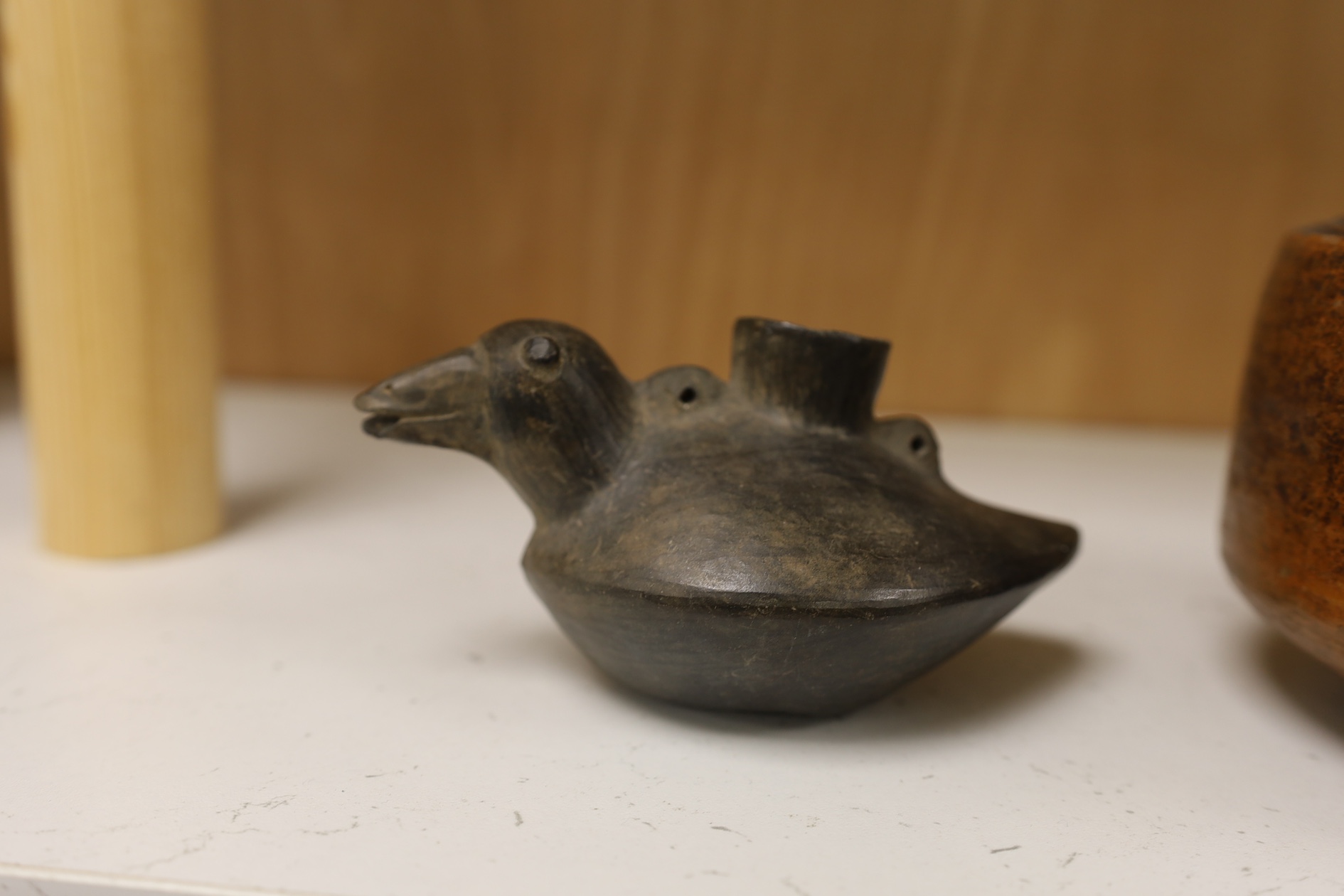 A black pottery bird vessel, probably pre-Columbian and a burnished terracotta jug, largest 15cm high. Condition - good for age